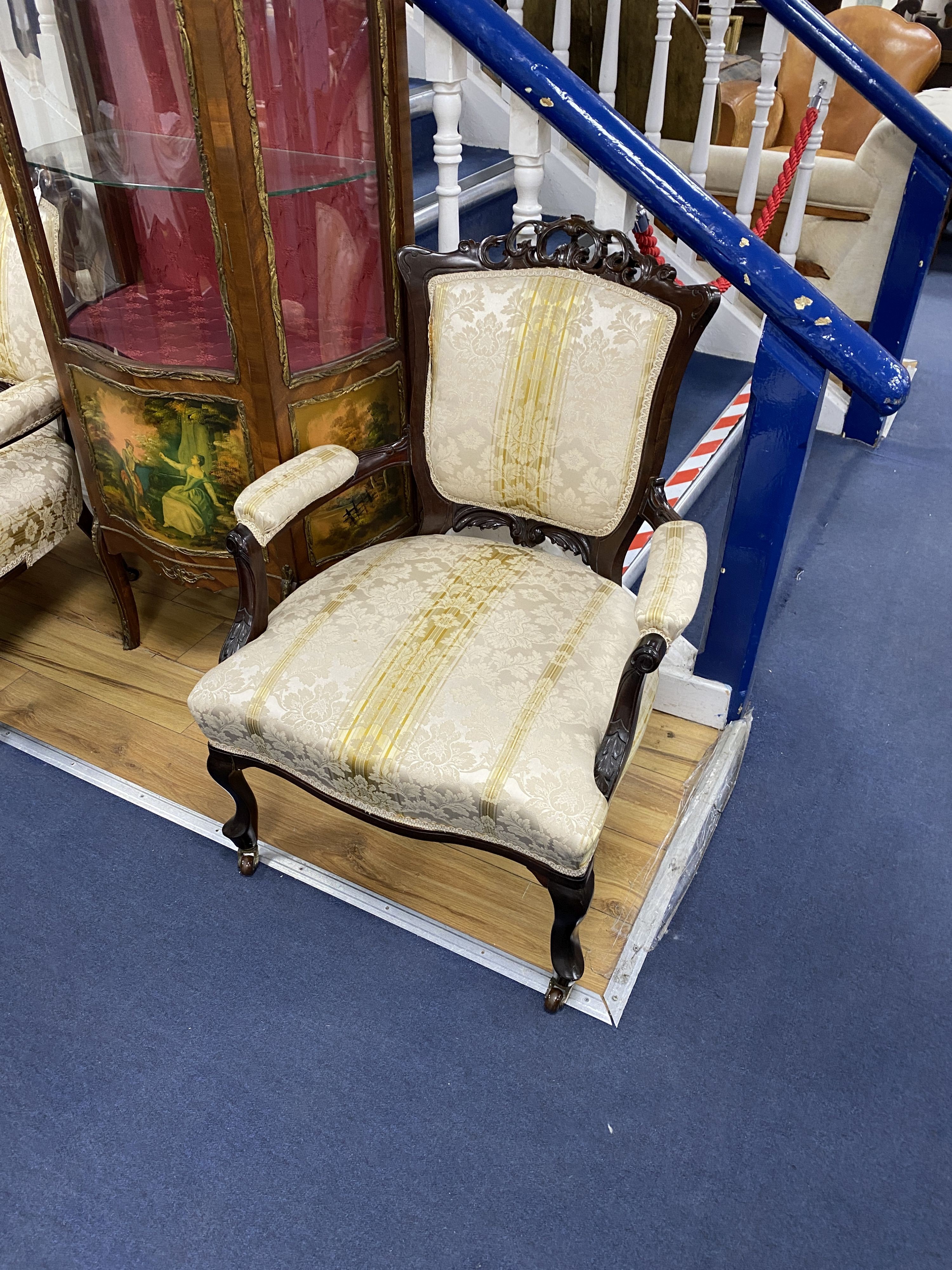 A pair of late Victorian carved mahogany open armchairs, width 66cm, depth 70cm, height 76cm